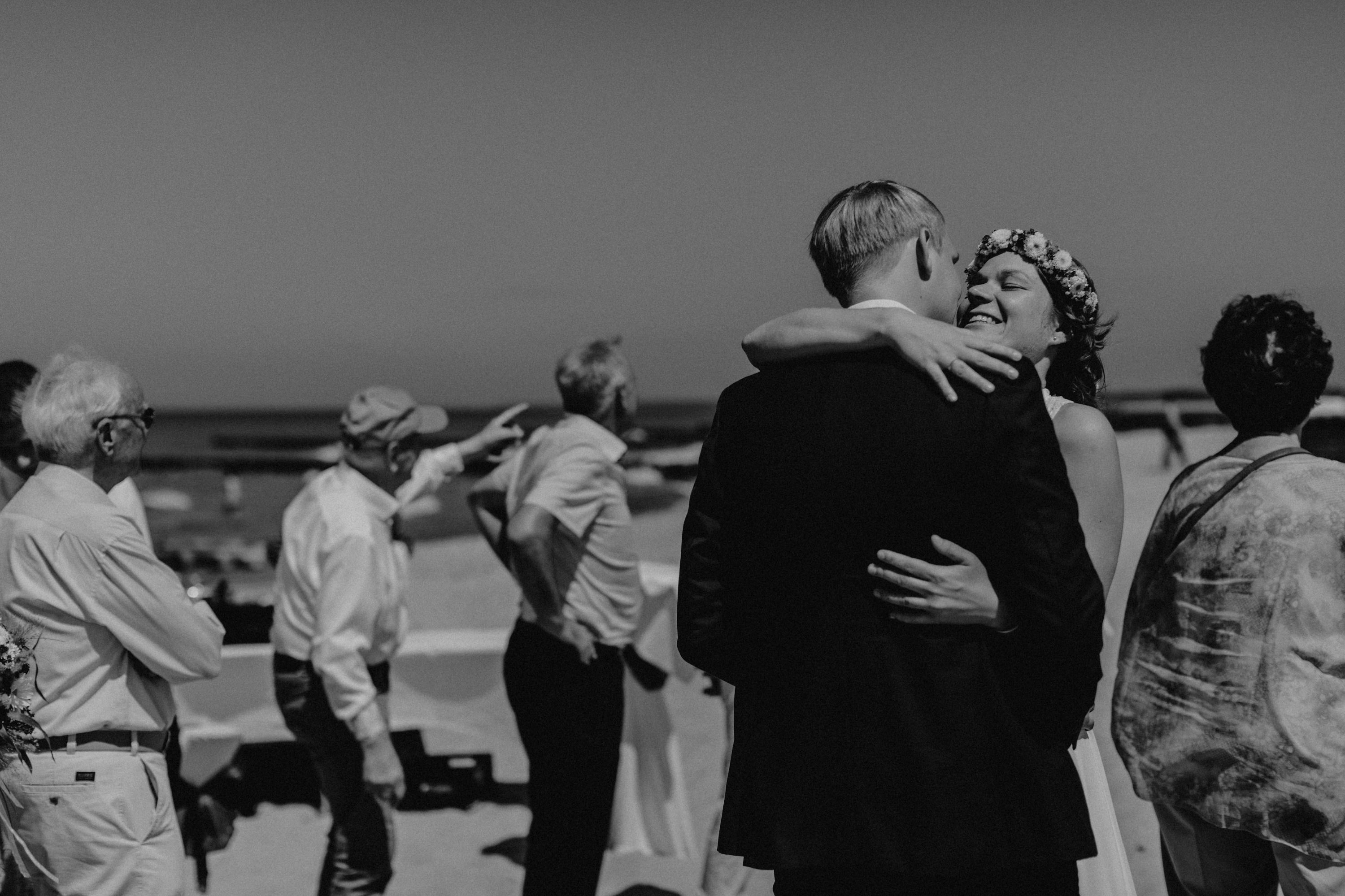 Strandhochzeit an der Ostsee. Es handelt sich um ein Foto aus einer Hochzeitsreportage, das von den beiden Hochzeitsfotografen Tom und Lia Fotografie aus Potsdam aufgenommen wurde. Die Hochzeit fand in Ahrenshoop direkt am Strand statt.